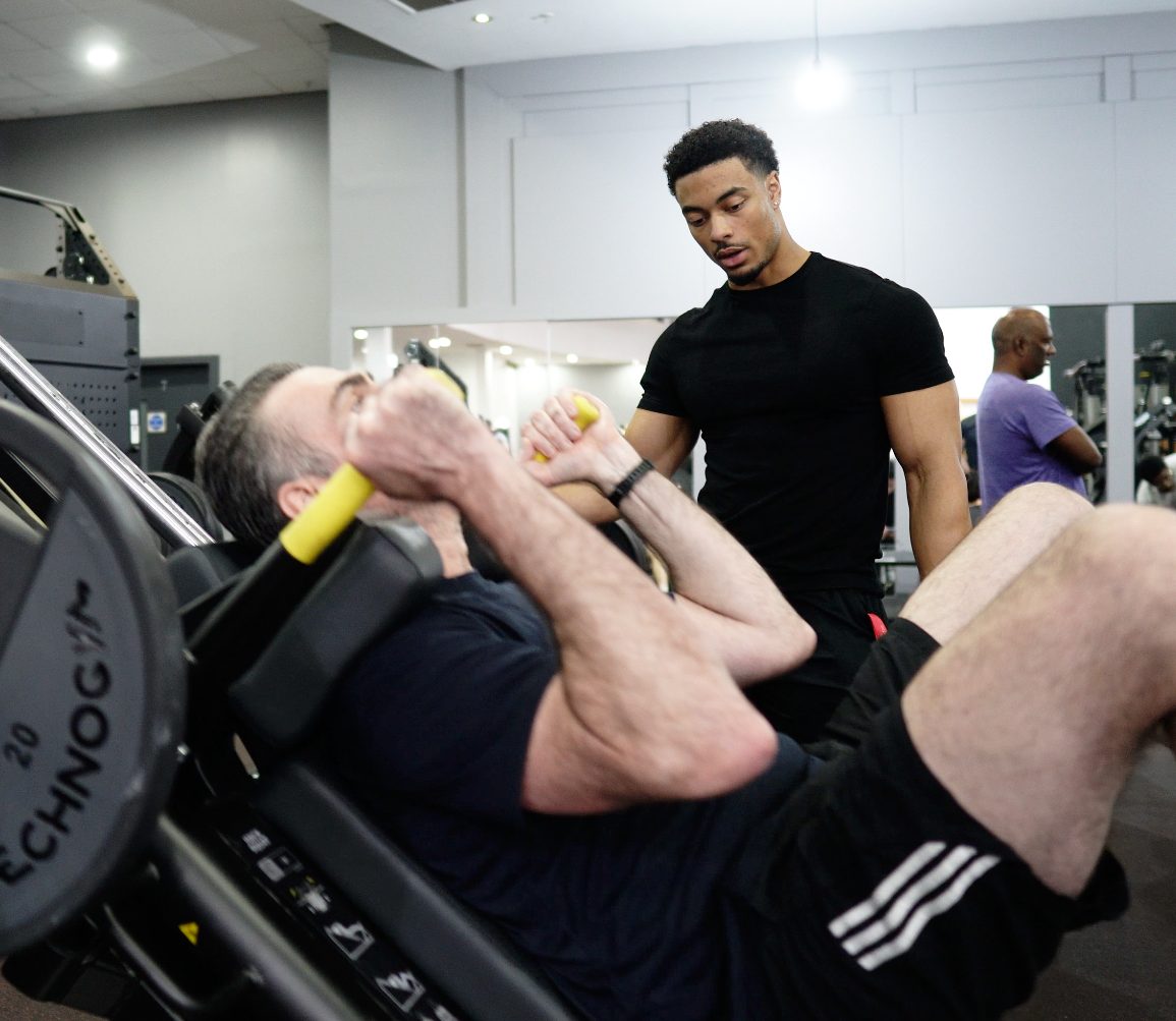 Jeffrey coaching a client through a leg press session