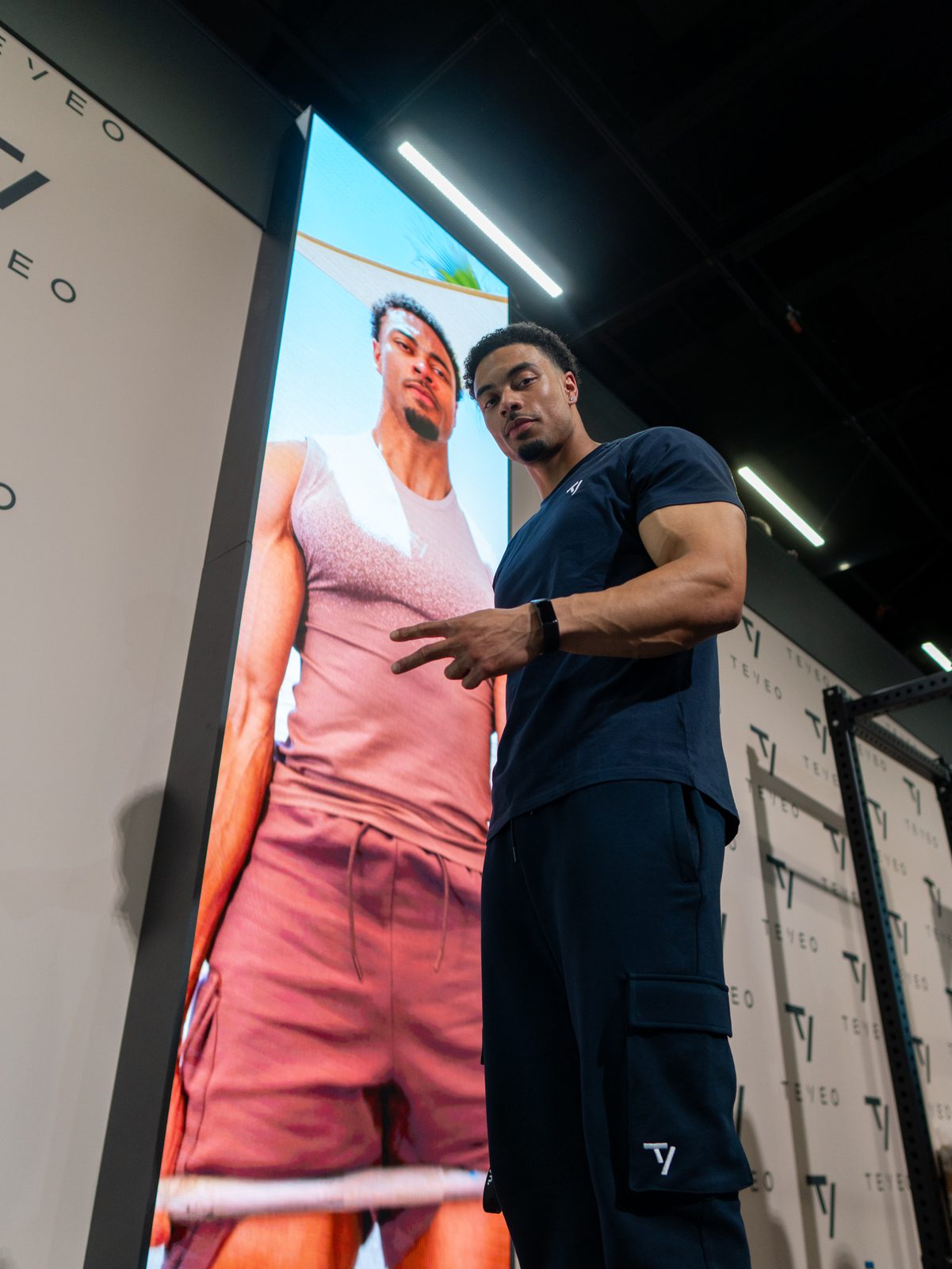 Jeffrey at a brand event in front of his own campaign display